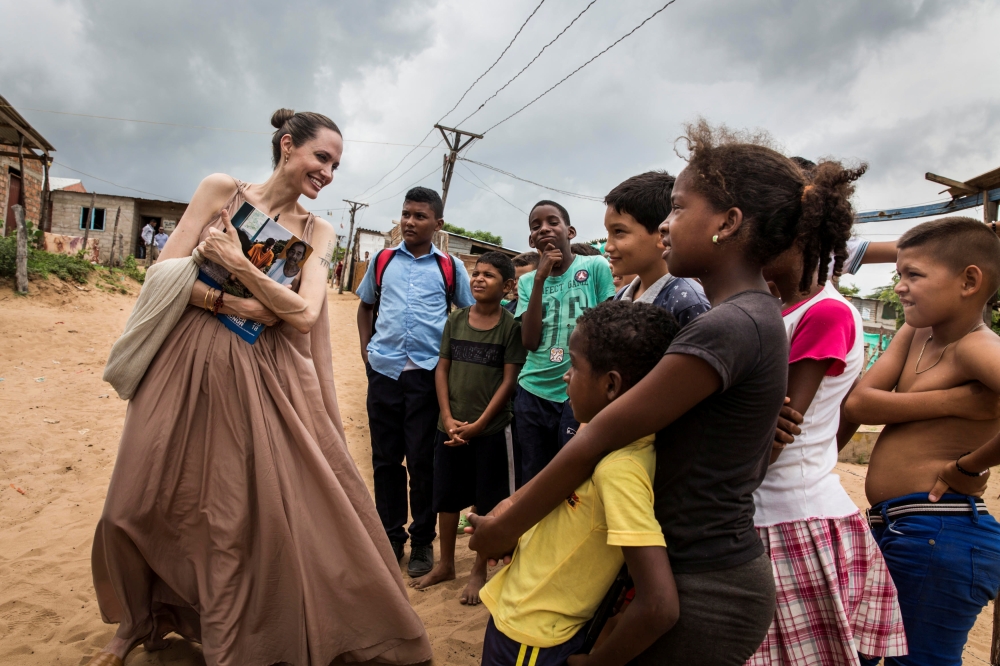 Special envoy for the United Nations High Commissioner for Refugees Angelina Jolie speaks to people in Riohacha, Colombia June 7, 2019. Courtesy of UNHCR/Andrew McConnell