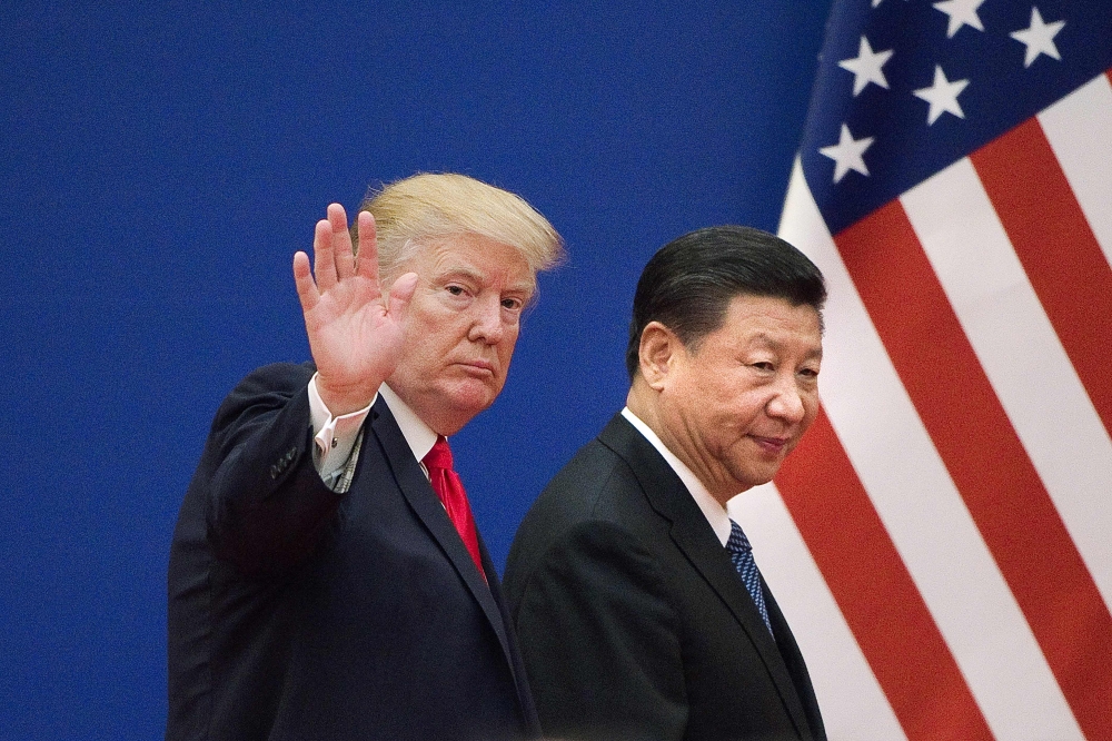 FILE PHOTO: US President Donald Trump (L) and China's President Xi Jinping leaving a business leaders event at the Great Hall of the People in Beijing. AFP / Nicolas ASFOURI