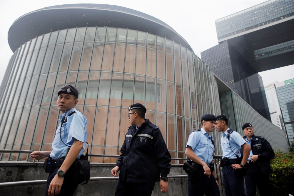 Policemen patrol outside the Legislative Council building ahead of tomorrow's hearing on the extradition bill in Hong Kong, China, June 11, 2019. REUTERS/Thomas Peter