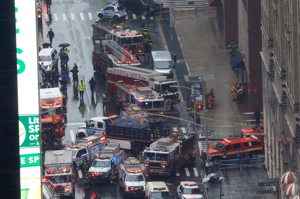 Emergency vehicles are seen outside 787 7th Avenue in midtown Manhattan where a helicopter crashed in New York City, New York, U.S., June 10, 2019. REUTERS/Mike Segar
