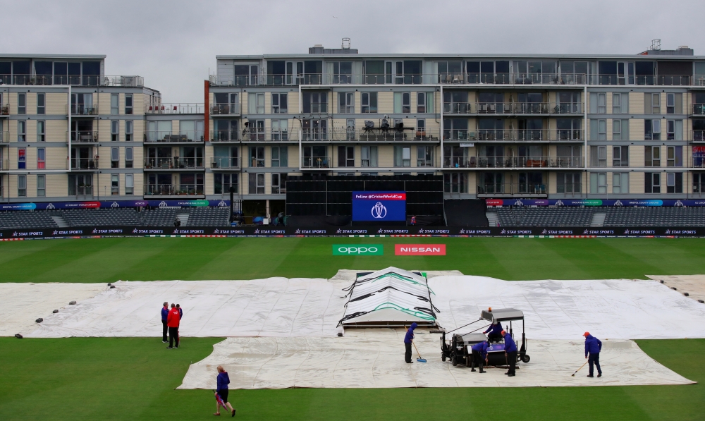 Groundstaff work on the field before play. Reuters/Andrew Couldridge