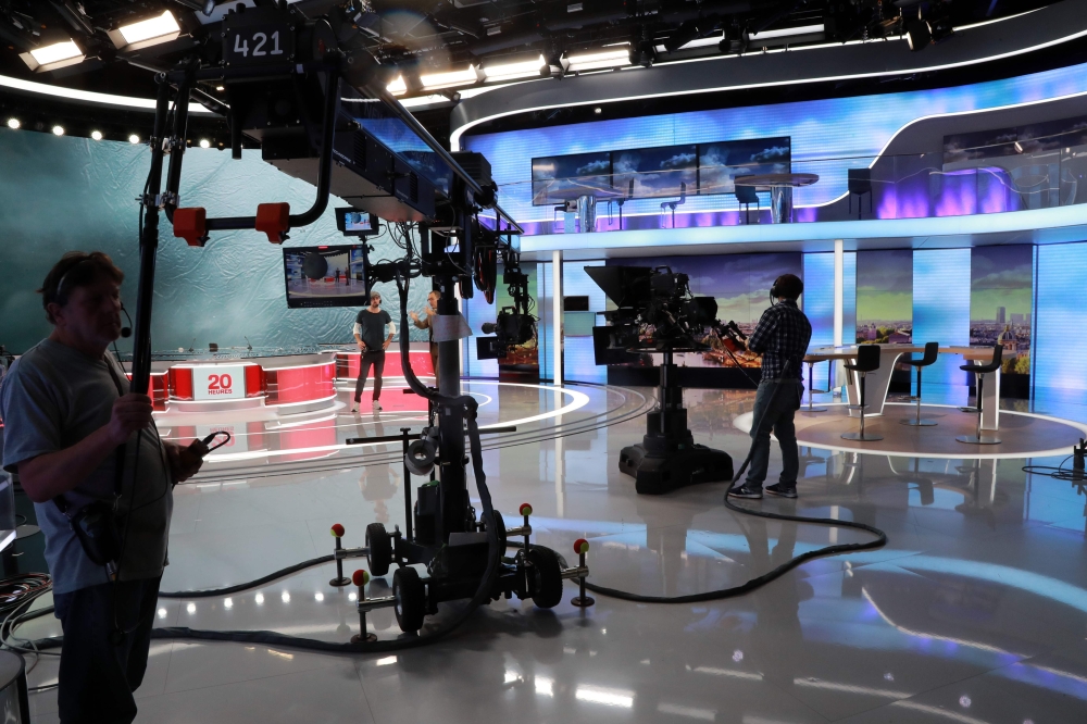 In this file photo taken on September 14, 2017, technicians wait on the set before the broadcast news of the French TV channel France 2 in Paris. AFP / Jacques Demarthon 