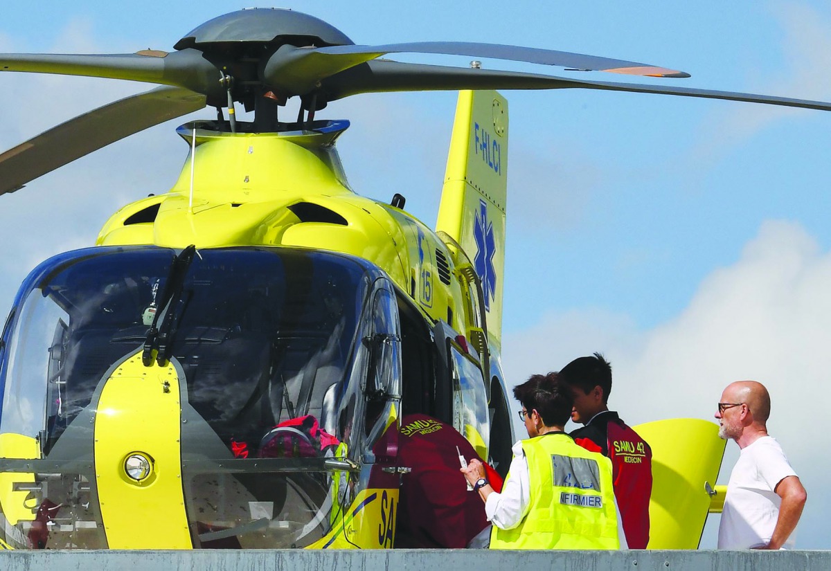 Doctors and a nurse are seen on the roof of the Centre Hospitalier of Roanne, from where Team Ineos rider Great Britain's Christopher Froome is to be transferred by helicopter to another hospital, after he fell on a training run ahead of the fourth stage 