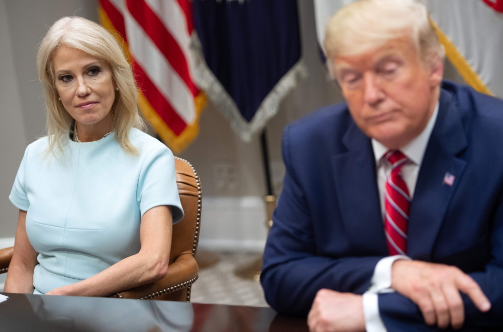 In this file photo taken on June 12, 2019 US President Donald Trump sits alongside Kellyanne Conway (L), Counselor to the President, during a meeting on the opioid epidemic in the Roosevelt Room of the White House in Washington, DC.  AFP / Saul Loeb 