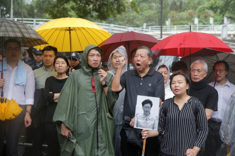 Pro-democracy legislators speak to the media demanding the Hong Kong Chief Executive Carrie Lam withdraw a controversial extradition bill outside Government House, following a day of violence over an extradition bill that would allow people to be sent to 