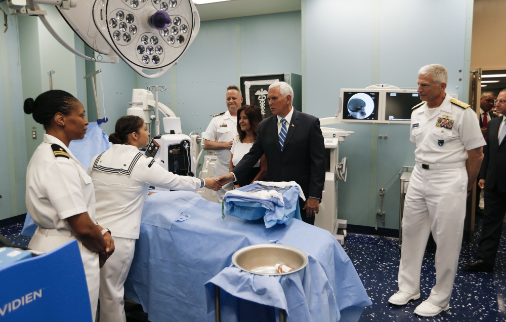 US Vice President Mike Pence greets Naval medical staff with his wife Karen as Navy Admiral Craig Faller, right, commander of the U.S. Souther Command looks on as he toured the US Navy Hospital Ship USNS Comfort on June 18, 2019 in Miami, Florida. Joe Ski