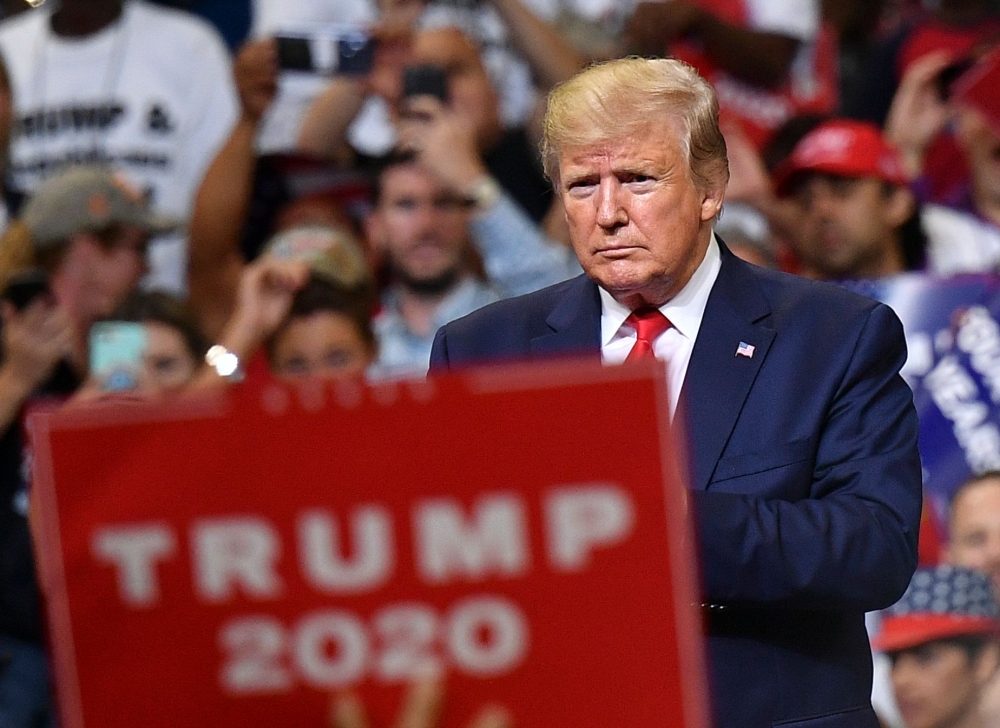 US President Donald Trump looks on during a rally at the Amway Center in Orlando, Florida to officially launch his 2020 campaign on June 18, 2019. / AFP / MANDEL NGAN