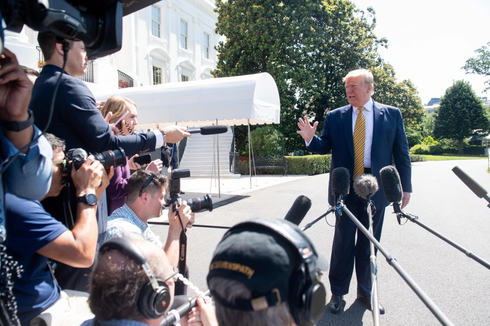 US President Donald Trump speaks to the media prior to departing on Marine One from the South Lawn of the White House in Washington, DC, June 22, 2019, as he travels to Camp David, Maryland. / AFP / SAUL LOEB