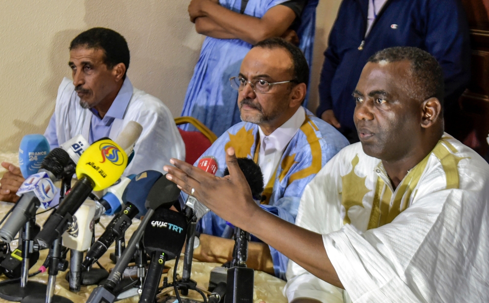 Mohamed Ould Boubacar (C), Biram Ould Dah Ould Abeid (R) and Mohamed Ould Mouloud (L) attend a press conference in Nouakchoot on June 23, 2019, a day after the country's presidential election first round. AFP / SIA KAMBOU