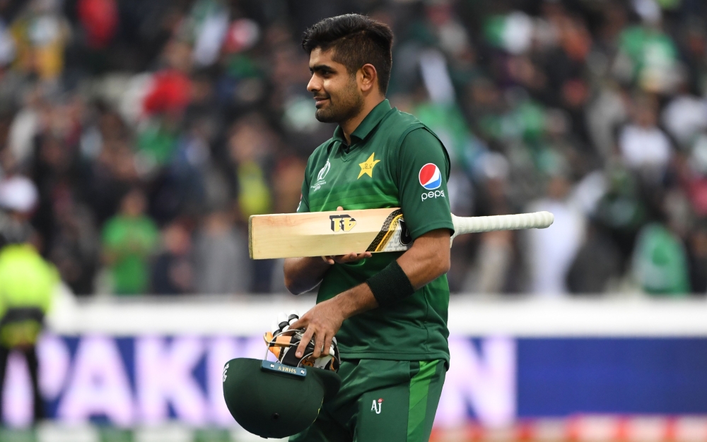 Pakistan's Babar Azam walks off the field as he celebrates after victory in the 2019 Cricket World Cup group stage match between New Zealand and Pakistan at Edgbaston in Birmingham, central England, on June 26, 2019.  AFP / Paul Ellis