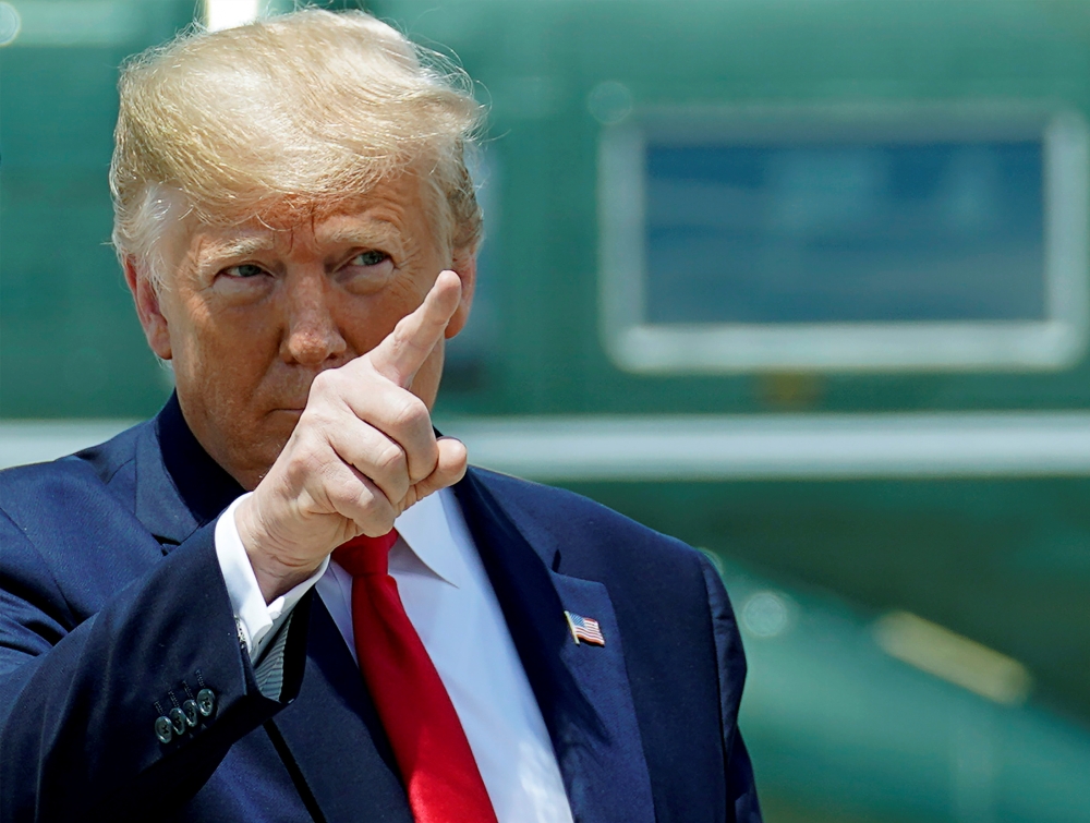 US President Donald Trump walks to board Air Force One as he departs Washington for travel to the G20 summit in Osaka, Japan from Joint Base Andrews, Maryland, U.S., June 26, 2019. REUTERS/Kevin Lamarque