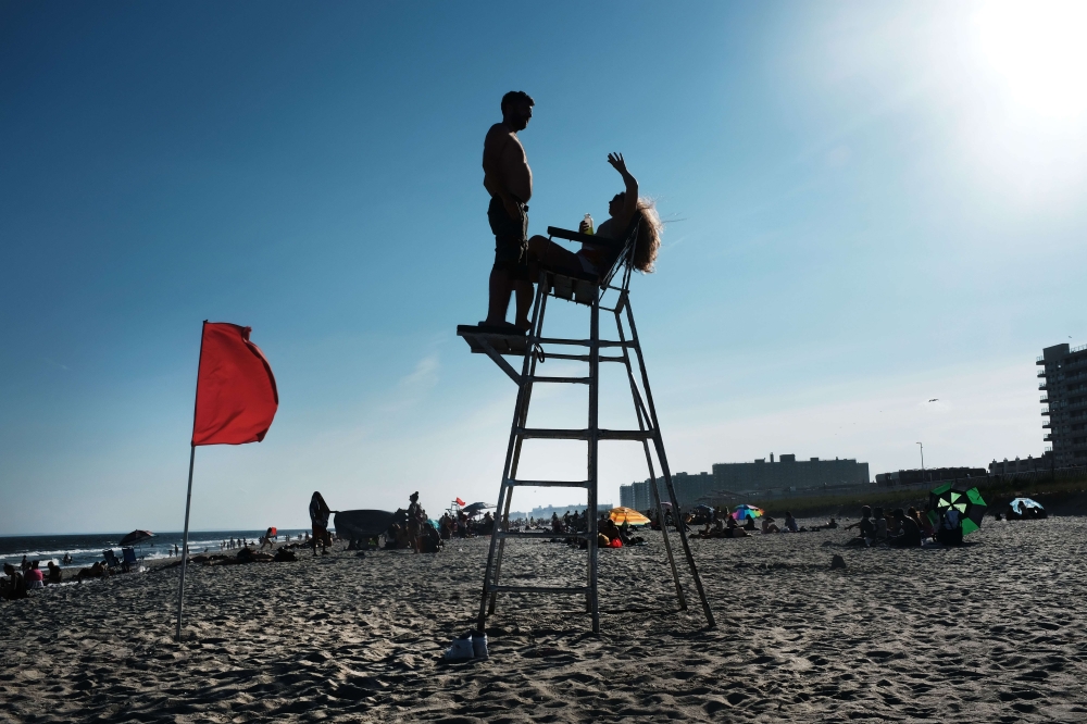 People enjoy an afternoon at the beach on the last day of school in New York on June 26, 2019 in New York City.  Spencer Platt/Getty Images/AFP