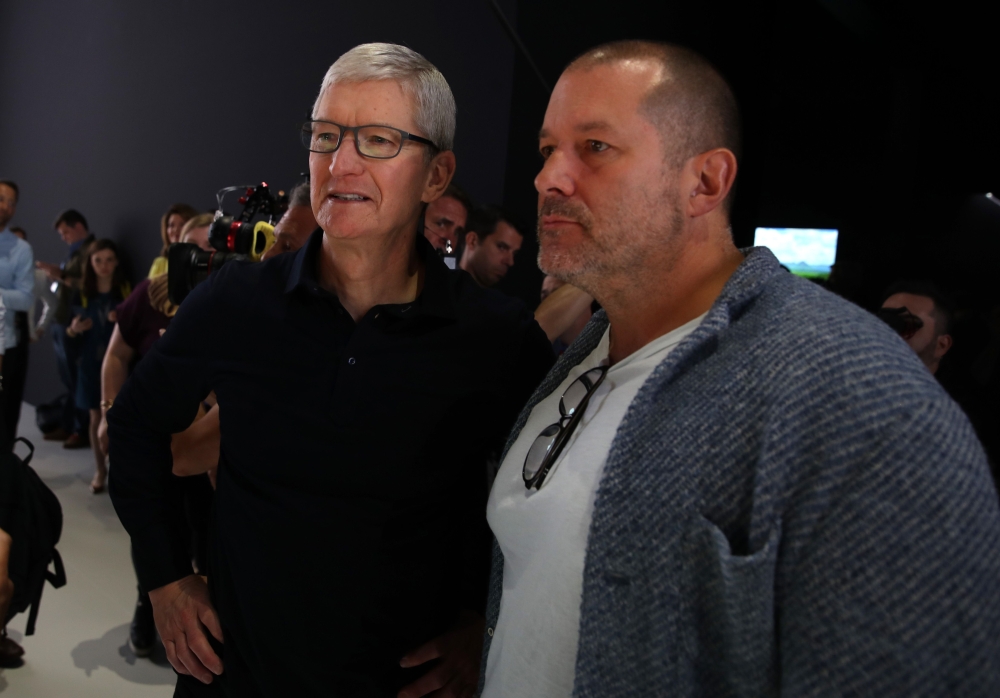 In this file photo taken on June 3, 2019 Apple CEO Tim Cook (L) and Apple chief design officer Jony Ive (R) look at the new Mac Pro during the 2019 Apple Worldwide Developer Conference (WWDC) at the San Jose Convention Center in San Jose, California. / AF