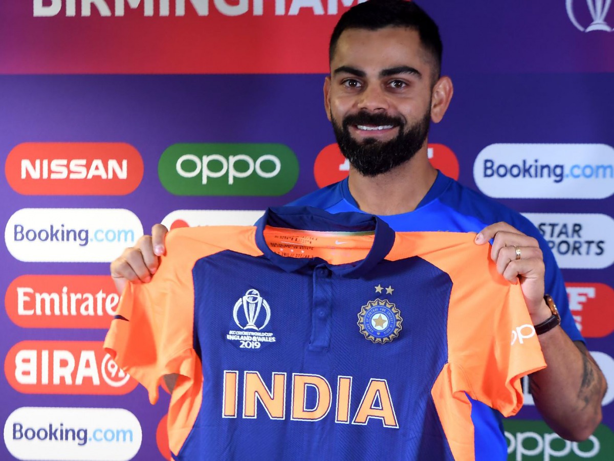 India's captain Virat Kohli poses with his new team colours during a press conference at Edgbaston in Birmingham, central England on June 29, 2019, ahead of their 2019 Cricket World Cup group stage match against England. AFP / Dibyangshu Sarkar 