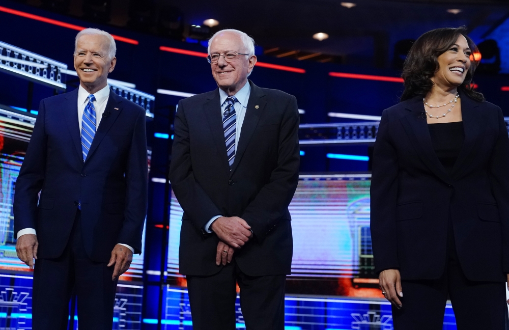 Democratic US 2020 election presidential candidates former Vice President Joe Biden, Senator Bernie Sanders and Senator Kamala Harris pose before the start of the second US 2020 presidential election Democratic candidates debate in Miami, June 27, 2019. R
