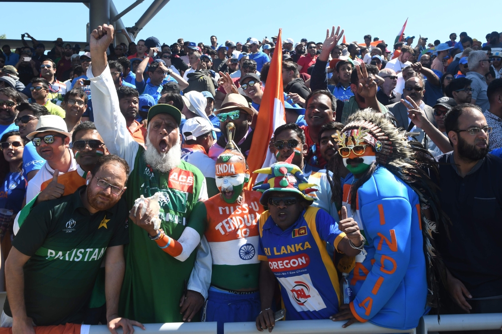 Pakistan (L) and Indian super fans cheer during the 2019 Cricket World Cup group stage match between West Indies and India at Old Trafford in Manchester, northwest England, on June 27, 2019. / AFP / Dibyangshu Sarkar