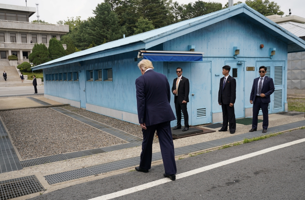 US President Donald Trump walks to meet with North Korean leader Kim Jong Un at the demilitarized zone separating the two Koreas, in Panmunjom, South Korea, June 30, 2019. (REUTERS/Kevin Lamarque)