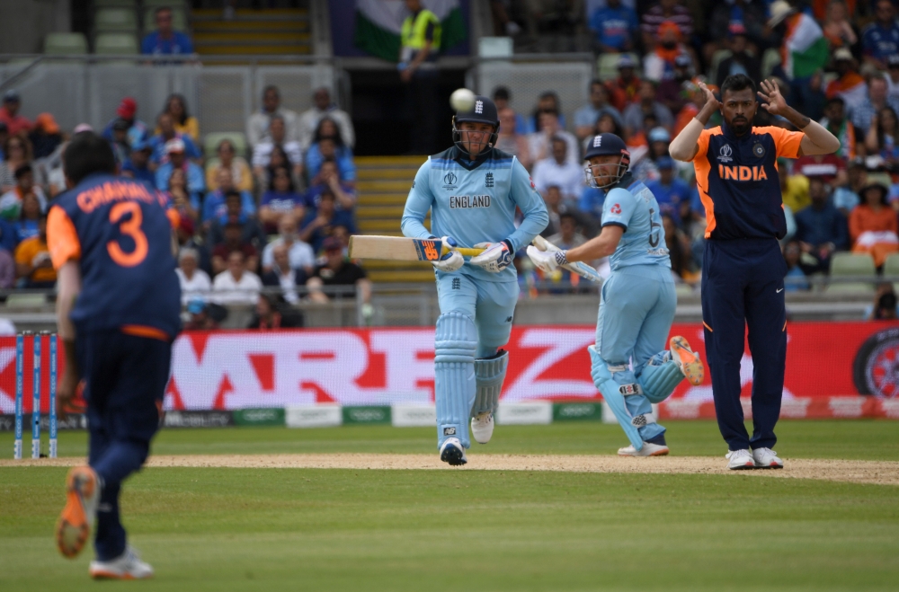 England's Jason Roy (C) and teammate Jonny Bairstow (2R) look on as India's Yuzvendra Chahal (L) fields the ball towards India's Hardik Pandya (R) during the 2019 Cricket World Cup group stage match between England and India at Edgbaston in Birmingham, ce