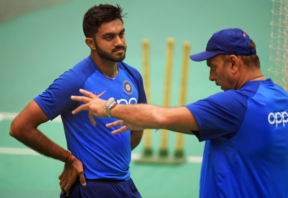 India's head coach Ravi Shastri (R) talks with India's Vijay Shankar during a training session at Old Trafford in Manchester, northwest England on June 25, 2019, ahead of their 2019 Cricket World Cup group stage match against West Indies. AFP / Dibyangshu