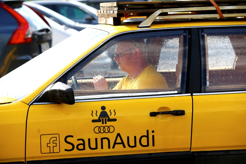 Willem Maesalu, inventor and owner of the old yellow Audi car converted into a small sauna, drives in the parking lot in Tallinn, Estonia June 27, 2019. Picture taken June 27, 2019. REUTERS/Ints Kalnins