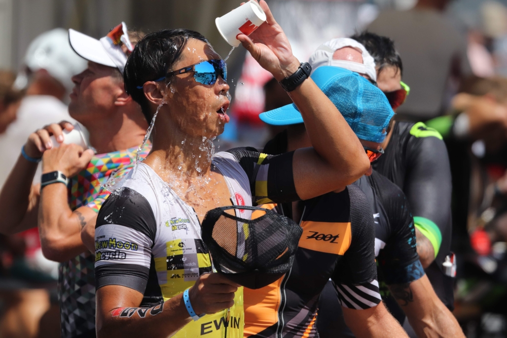 An athlete pours water on his face as he competes in an Ironman race in Frankfurt am Main, western Germany, where temperatures reached almost 39 degrees on June 30, 2019. AFP / Yann Schreiber 