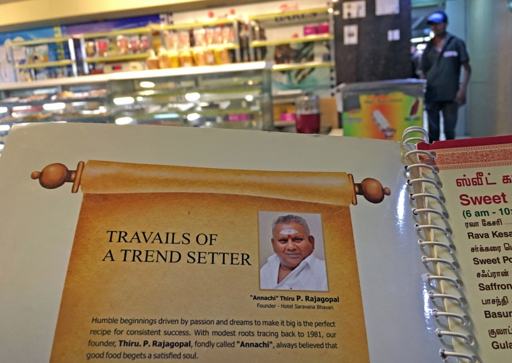 This photo taken on June 28, 2019 shows the image of P. Rajagopal, founder of the Saravana Bhavan food chain, on a menu at one of the popular restaurants in Chennai./ AFP / ARUN SANKAR 