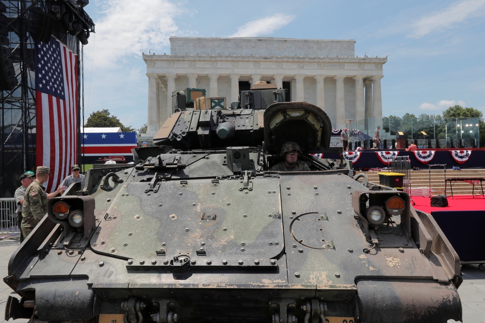 Members of the U.S. Army's 3rd Infantry Division, 1st Battalion, 64th Armored Regiment based at Fort Stewart, Georgia assist as a Bradley Fighting Vehicle is moved into place at the Lincoln Memorial ahead of a July Fourth celebration highlighting U.S. mil