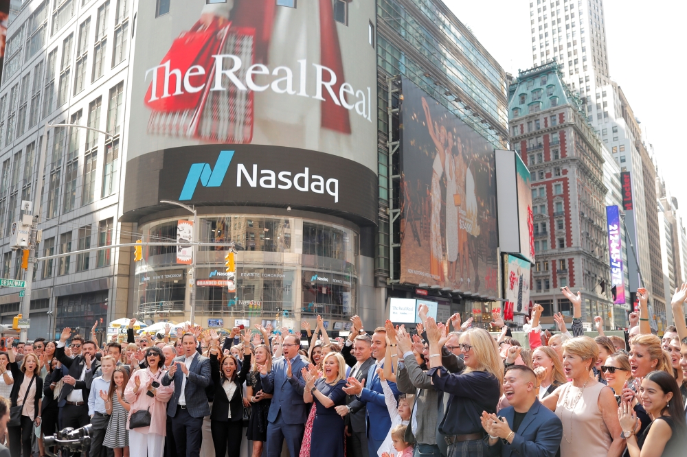 Julie Wainwright (C), CEO of The RealReal Inc. stands in Times Square to celebrate the company's IPO at the Nasdaq MarketSite in New York, U.S., June 28, 2019. Reuters/Lucas Jackson