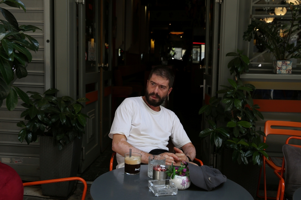 Supermarket worker Panagiotis Mitrogiannis, 39, poses for a picture after an interview with Reuters in Athens, Greece June 26, 2019. Picture taken June 26, 2019. Reuters/Costas Baltas