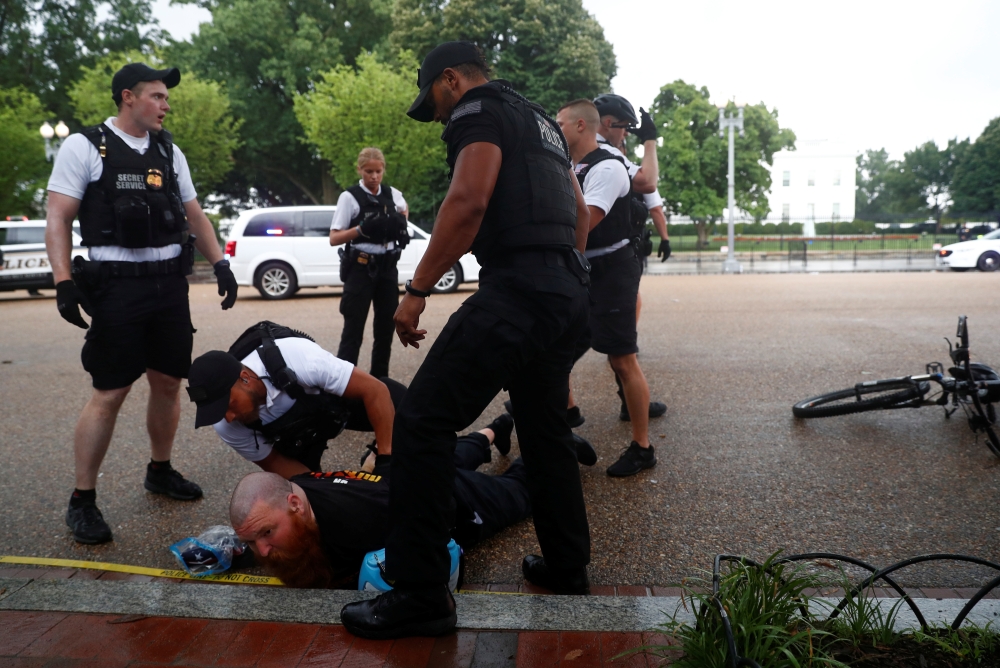 US Secret Service Uniformed Division officers detain a man in front of the White House during a Fourth of July Independence Day protest in Washington, July 4, 2019. Reuters/Eric Thayer