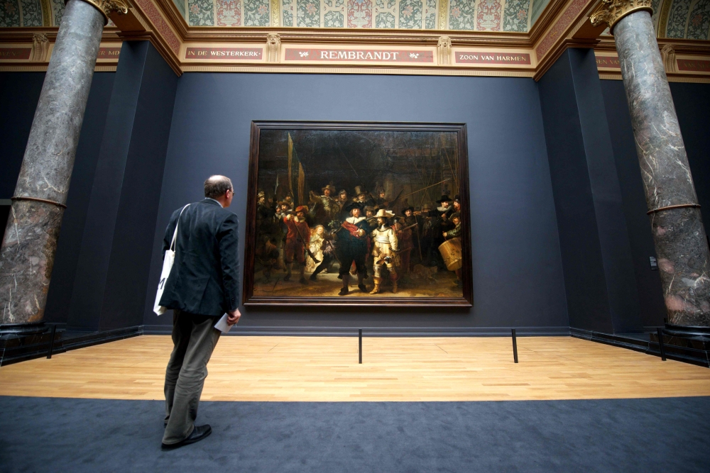 In this file photo taken on April 4, 2013, a visitor admires Rembrandt's masterpiece 