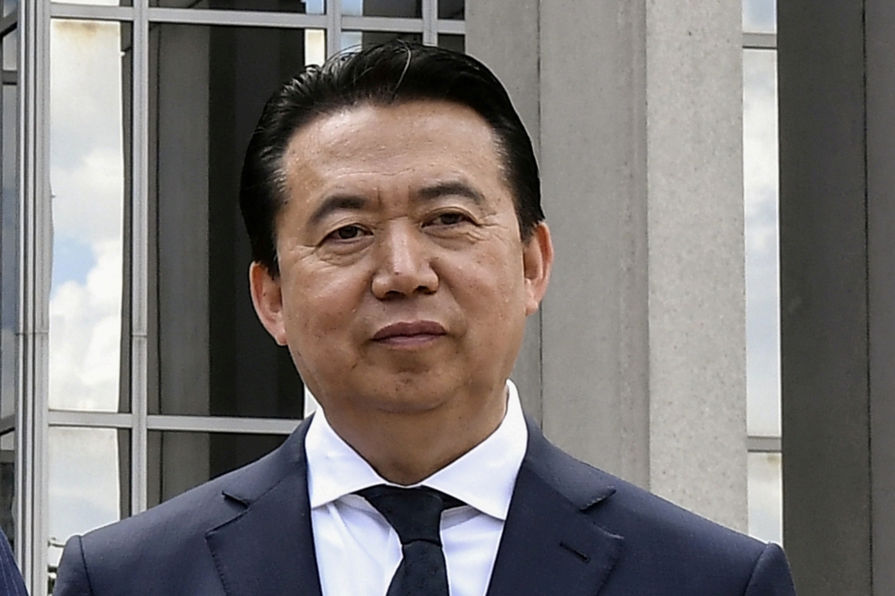 FILE PHOTO: INTERPOL President Meng Hongwei poses during a visit to the headquarters of International Police Organisation in Lyon, France, May 8, 2018. Picture taken May 8, 2018. Jeff Pachoud/Pool via Reuters/File Photo