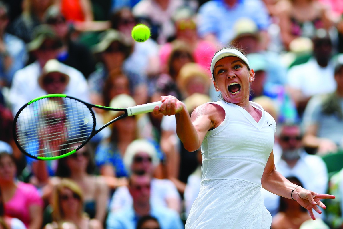 Romania's Simona Halep returns against Ukraine's Elina Svitolina during their women's singles semi-final match on day ten of the 2019 Wimbledon Championships at The All England Lawn Tennis Club in Wimbledon, southwest London, on July 11, 2019. AFP / Danie