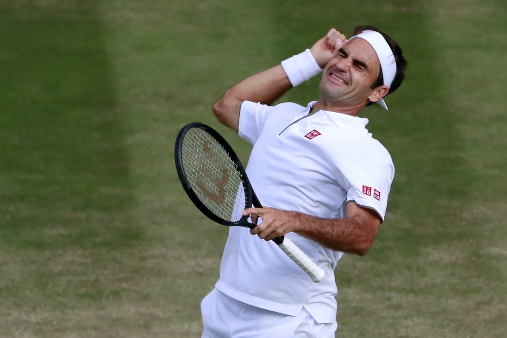 Switzerland's Roger Federer celebrates beating Spain's Rafael Nadal during their men's singles semi-final match on day 11 of the 2019 Wimbledon Championships at The All England Lawn Tennis Club in Wimbledon, southwest London, on July 12, 2019. AFP / Pool 