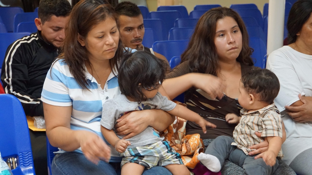 In this file photo taken on June 15, 2018 mothers and children wait to be assisted by volunteers in a humanitarian center in the border town of McAllen, Texas. AFP/Leila Macor