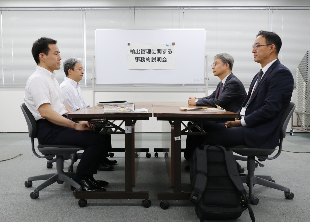 Working level officials from Japan (L) and South Korea hold a meeting about Japan's recent restrictions on exports of high-tech material to South Korea in Tokyo, Japan, July 12, 2019. Japan Pool/Pool via REUTERS