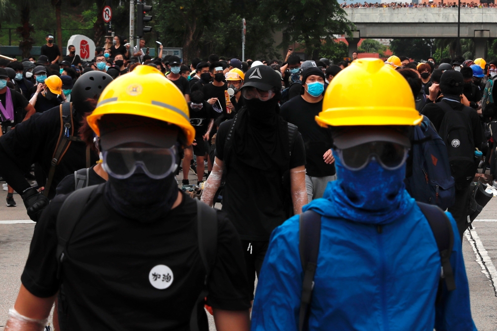 Anti-extradition bill protesters set up barriers as they face riot police after a march at Sha Tin District of East New Territories, Hong Kong, China July 14, 2019. REUTERS/Tyrone Siu
