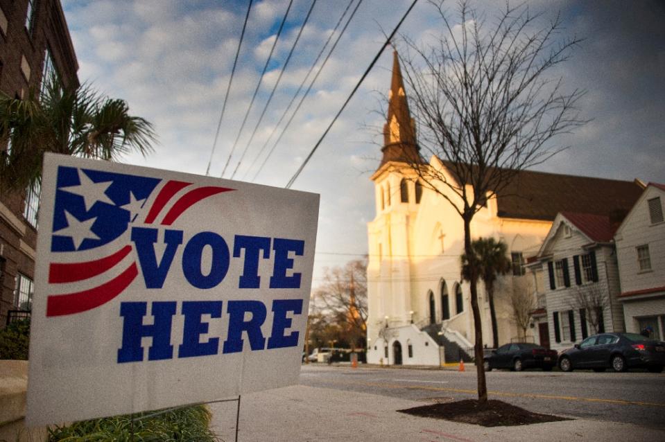A 'vote here' sign stands outside a polling station across from the Emanuel African Methodist Episcopal Church in Charleston, South Carolina on February 20, 2016. AFP/Jim Watson