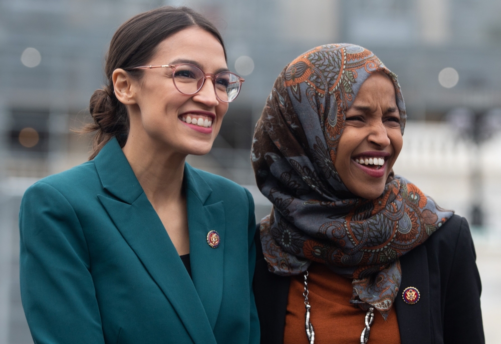 (FILES) In this file photo taken on February 7, 2019 US Representative Alexandria Ocasio-Cortez, Democrat of New York, and US Representative Ilhan Omar (R), Democrat of Minnesota, attend a press conference calling on Congress to cut funding for US Immigra