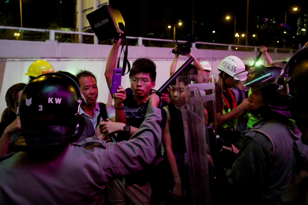 Riot police surround pro-democracy activist Joshua Wong (C) as they try to disperse protesters after a march at Sha Tin District of East New Territories, in Hong Kong, China July 14, 2019. (REUTERS/Tyrone Siu)