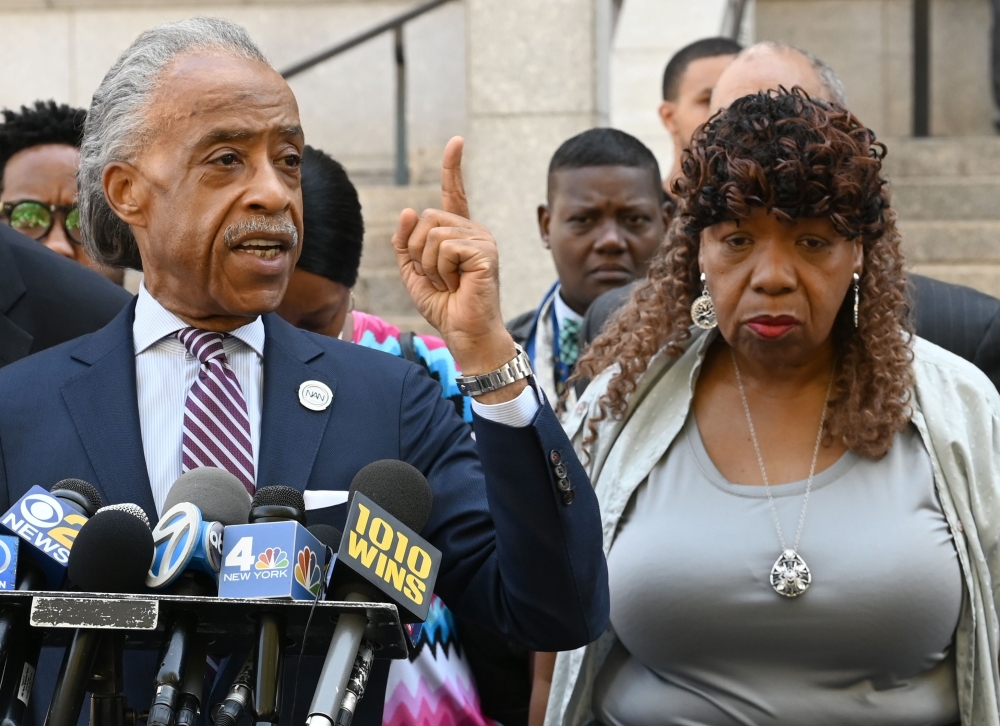 National Action Network founder and President Rev. Al Sharpton speaks to the media alongside Eric Garner's mother Gwen Carr (R) outside the Eastern District of New York on July 16, 2019.   (AFP / Timothy A Clary)
