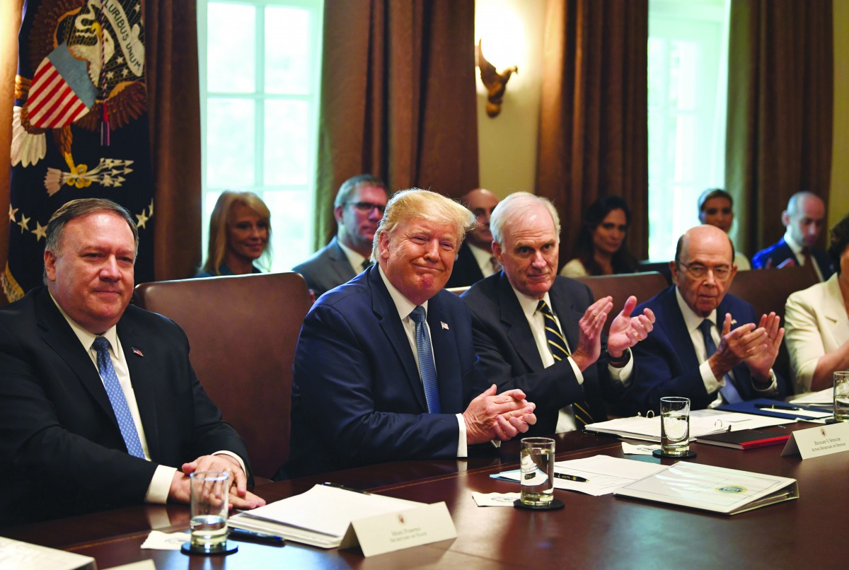 US President Donald Trump and others applaud outgoing Secretary of Labor Alexander Acosta as they participate in a Cabinet meeting at the White House on July 16, 2019 in Washington,DC. AFP / Nicholas Kamm