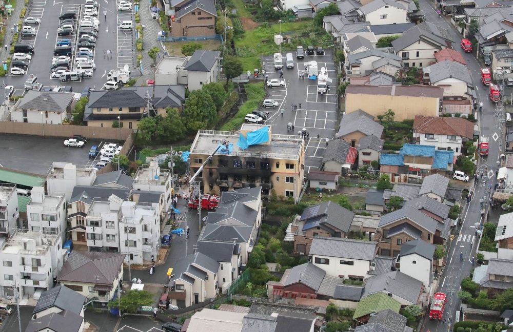 This aerial view shows the rescue and recover scene (C) after a fire at an animation company building killed some two dozen people in Kyoto on July 18, 2019. (AFP / JIJI PRESS)