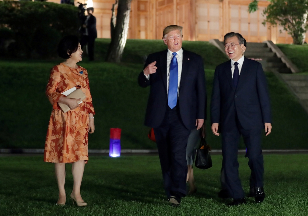 US President Donald Trump and South Korean President Moon Jae-in leave after a banquet at the Presidential Blue House in Seoul, South Korea, June 29, 2019. (Yonhap via Reuters) 