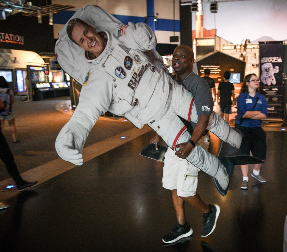 A museum employee carries a life-sized astronaut cutout of NASA Administrator Jim Bridenstine, during the Apollo 11, 50th Live celebration at Space Center Houston on July 19, 2019, in Houston, Texas. AFP / Loren Elliott 