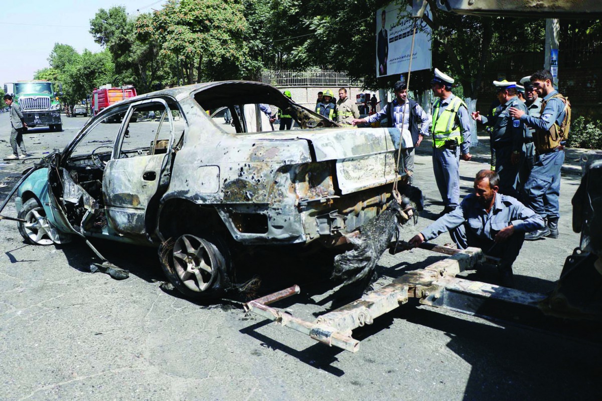 Afghan security officials inspect the scene of a bomb blast near the University of Afghanistan in Kabul, Afghanistan on July 19, 2019.  (Haroon Sabawoon/Anadolu Agency)