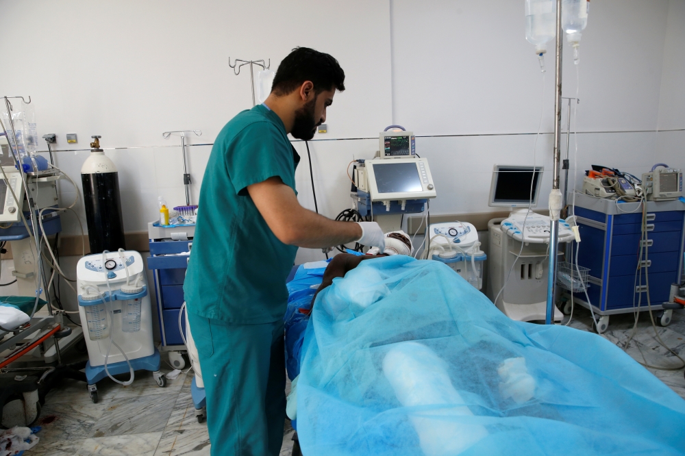 A wounded migrant receives medical care after an air strike hit a detention center for mainly African migrants in Tajoura, in Tripoli Central Hospital, Libya July 3, 2019. Reuters/Ismail Zitouny