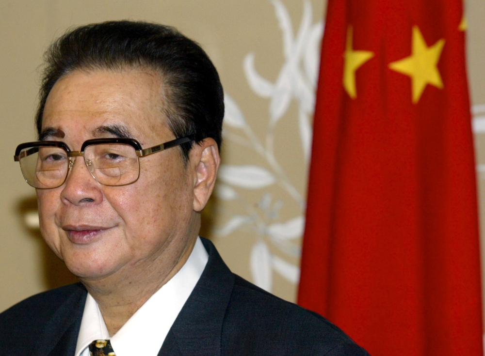 File photo of Chairman of the National Congress of the People's Republic of China Li Peng stands next to a Chinese flag in Canberra's Parliament House in Australia September 16, 2002. REUTERS/David Gray/File Photo