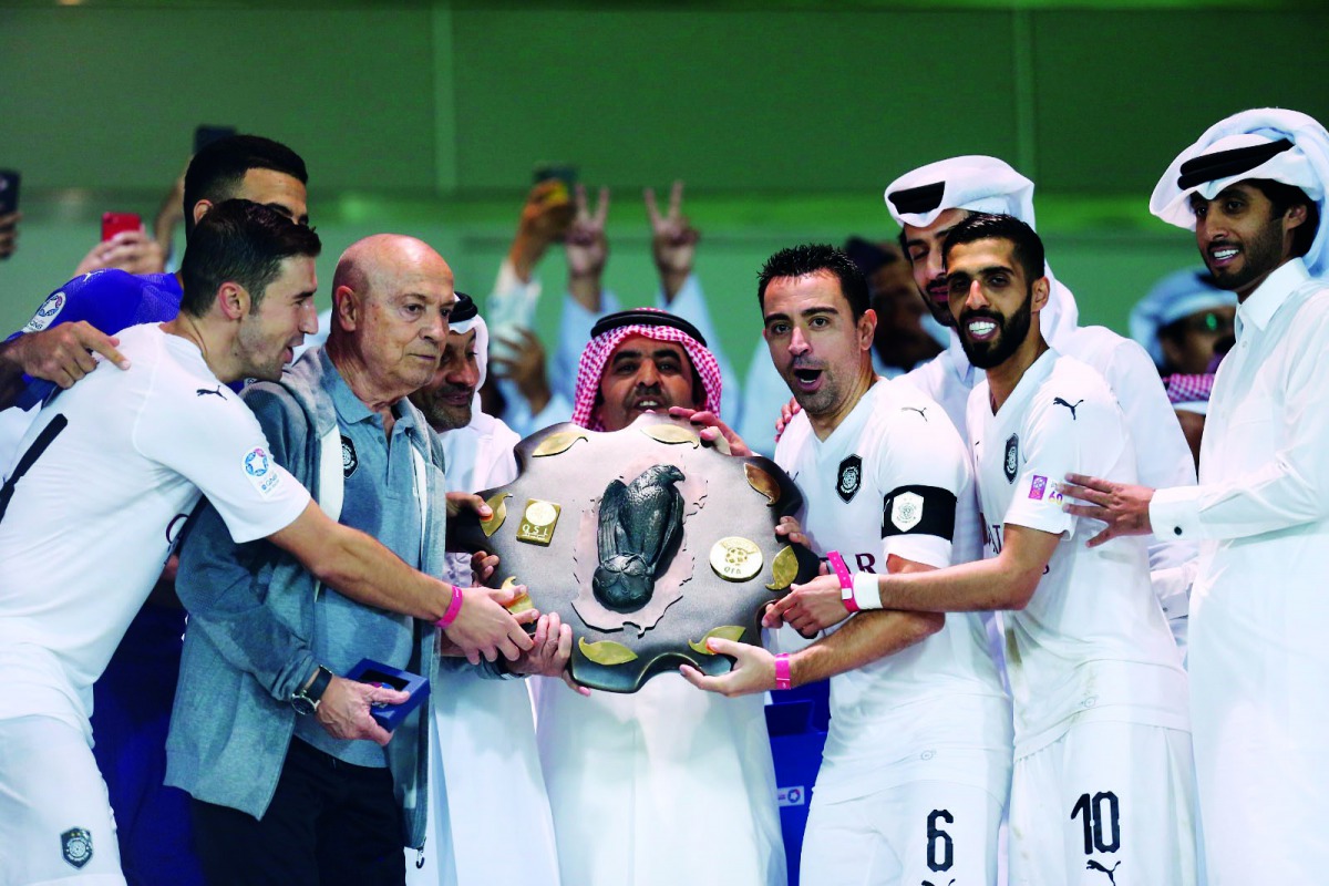 Al Sadd’s Spanish skipper Xavi Hernandez, coach Jesualdo Ferreira, players and officials hold the Falcon Shield after winning the 2018/19 QNB Stars League (QSL) title at the Al Sadd Stadium in this April 4 file photo.