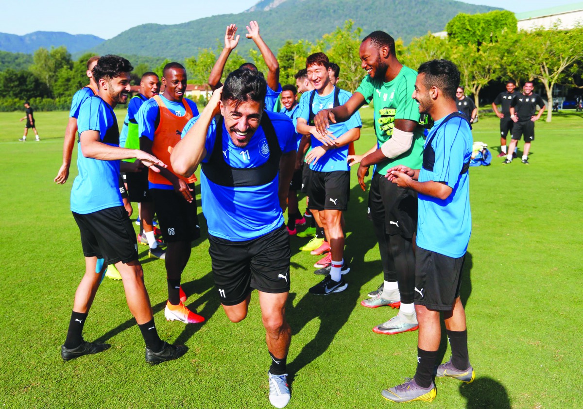 Al Sadd’s players sharing a light moment with their Algerian team-mate Baghdad Bounedjah as the feared striker returns to training in Olot, Spain, yesterday. 